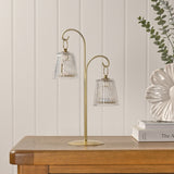 Hanging Shade Double LED Table Lamp 39.9cm in gold with two clear ribbed glass shades, shown on a wooden sideboard beside books and a vase.