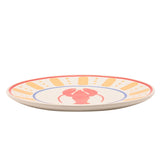 Side view of a round cream dinner plate with a red lobster at the centre, blue ring border, orange-yellow dashes and dots, and a red rim line, on a white background.