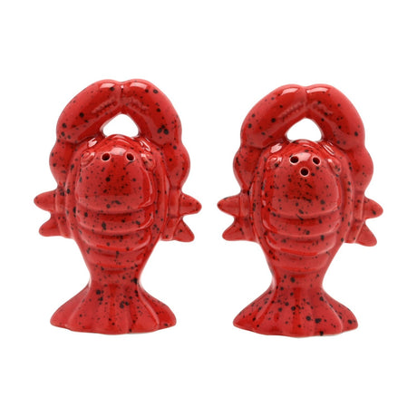 Speckled Lobster Salt & Pepper Set in Red, two ceramic pots shaped as upright lobsters with raised claws forming a loop, ridged bodies and fanned tails, on a plain white background.