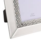 Close-up of a mirrored glass photo frame with bevelled silver edges and a diamante crystal border, shown for a 4x6in photo, with a black stand visible behind.