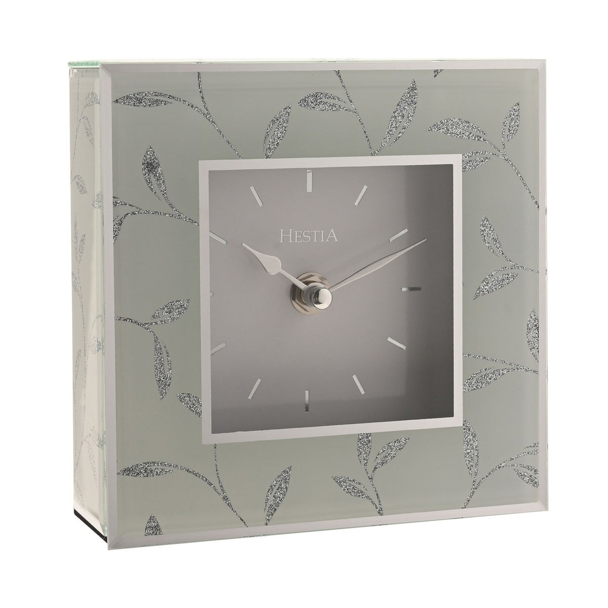 Square mantel clock with a grey dial and silver baton markers, framed by a pale border and glass sides decorated with silver glitter leaf stems, shown on a plain white background.