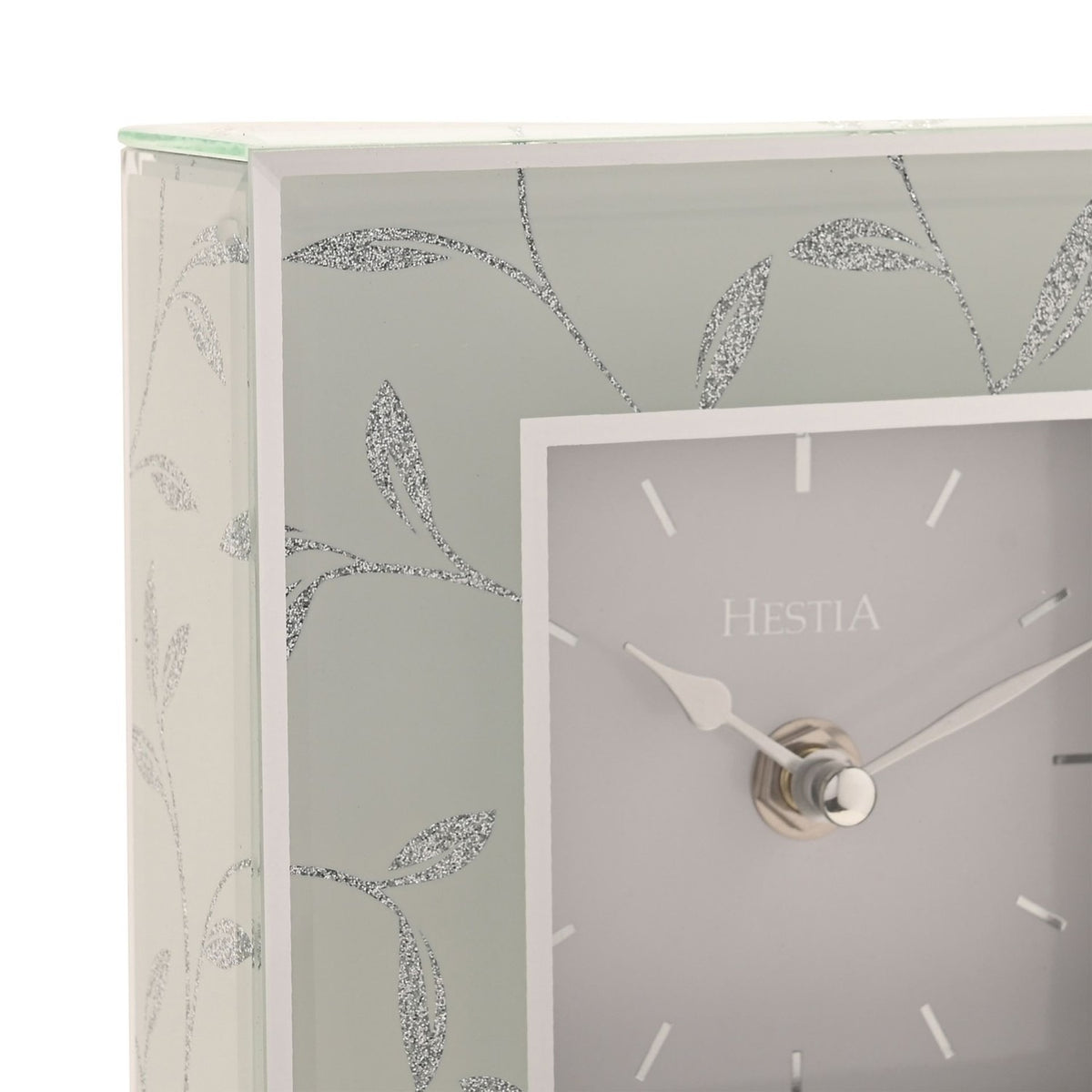 Close-up of the Square Glitter Leaf Design Mantel Clock in grey, showing the pale square dial with baton markers, silver hands, and silver glitter leaf motif on the corner edge.