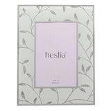 Rectangular glass photo frame with glittering silver leaf and vine design on a frosted white ground, holding a 4x6in insert, shown on a plain background.