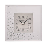 Square mirrored mantel clock in silver with scattered diamante accents and a white square dial featuring black Roman numerals, set against a plain white background.