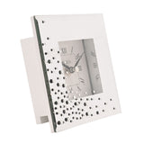 Square mirrored mantel clock with scattered diamante accents and a white Roman numeral dial, shown on a side stand against a plain white background.