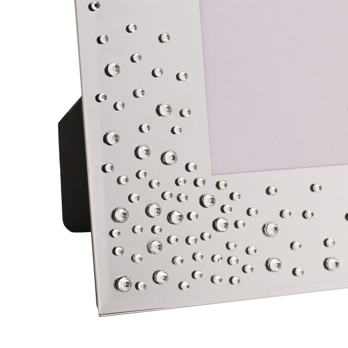 Close-up of a silver glass photo frame with a bevelled edge, clear diamantes clustered in the corner and scattered along the border, with a built-in easel stand.