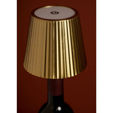 Wine bottle topper LED table lamp with a gold pleated tapered shade, white top touch control, and ridged stopper, shown fitted onto a dark bottle neck.