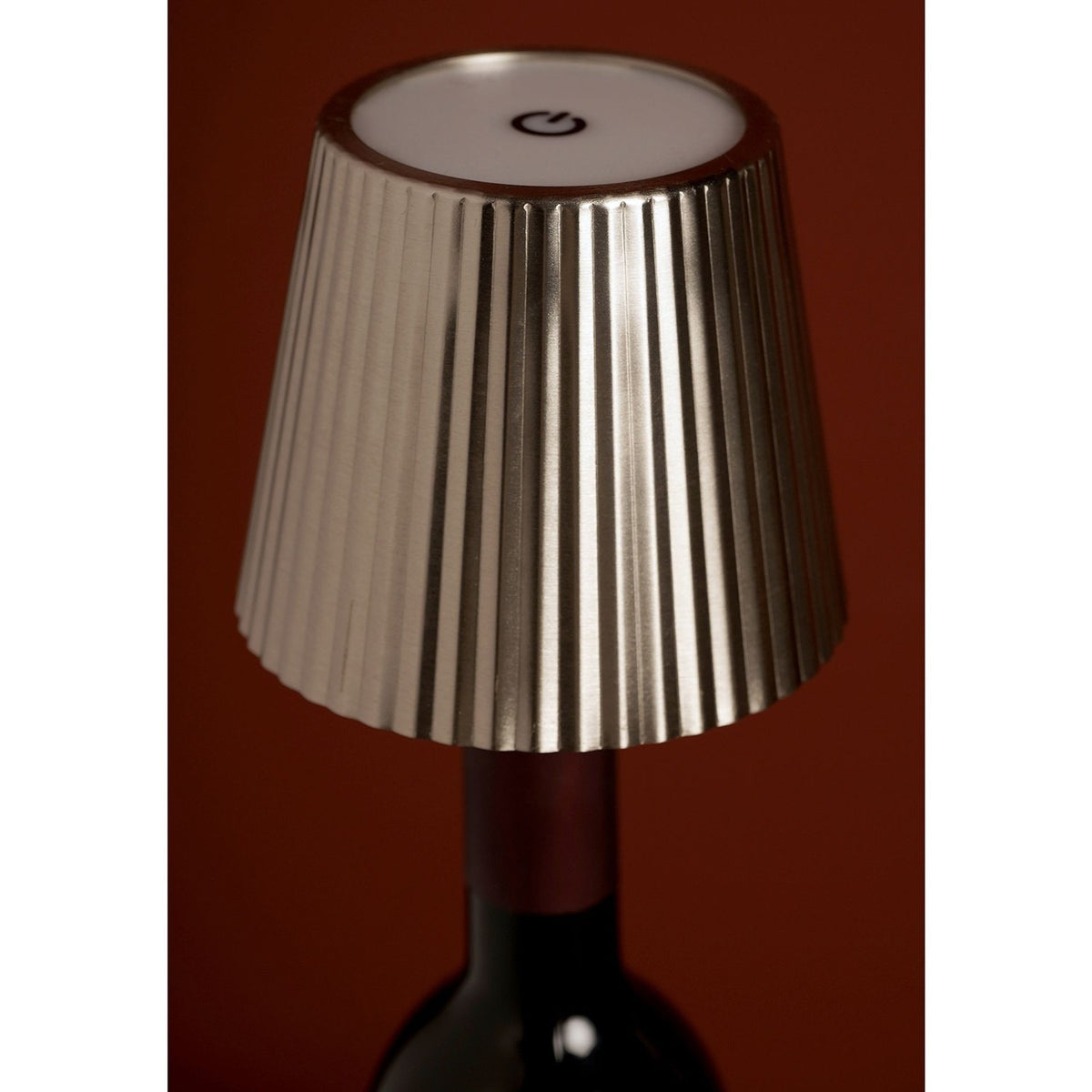 Round Wine Bottle Topper LED Touch Table Lamp in silver metal, pleated tapered shade with touch control on top, fitted onto a wine bottle neck.