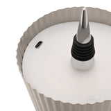 Close-up of the Round Wine Bottle Topper LED table lamp in silver metal, showing the pleated ribbed shade, pointed spike with ridged black rings, and USB-C port on the base.
