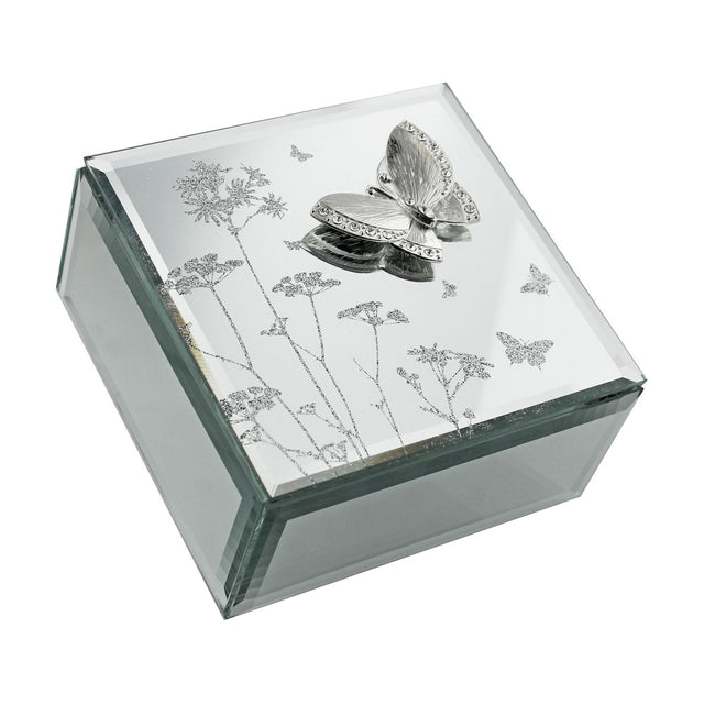 Square mirrored glass jewellery box in silver with a raised, jewelled butterfly and glittered wildflower design on the lid, shown on a plain white background.