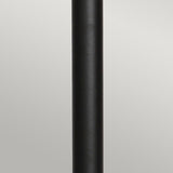 A close-up view of the Helsingor 1 Light Bollard Lantern with PIR in a sleek, vertical black design set against a neutral gray background. The lantern is centered in the image, showcasing its smooth, matte texture and emphasizing its IP44 rating for weather resistance.
