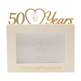 Cream MDF 6x4in photo frame with gold "50 Years" lettering and heart-shaped crystal drop above, "of love and happiness" text below, on a white background.