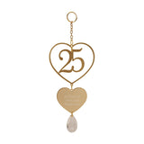 Gold hanging plaque featuring an open heart around a cut-out 25, a solid heart reading 25 years of love and happiness, a clear teardrop, and a chain with ring hanger, on a white background.