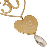 Gold metal hanging plaque with an open heart outline around a "30", a solid heart engraved "30 years of love and happiness", and a clear faceted teardrop, shown on a white background.