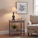 Hill Interiors Ormelle fluted wooden table lamp in grey-washed wood with linen shade, on a side table beside an armchair in a neutral living room.