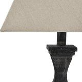 Close-up of the Hill Interiors Ormelle Fluted Wooden Table Lamp in grey-washed wood, showing the carved base detail and natural linen drum shade.