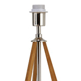 A close-up of the Hilton 1 Light Wood Table Lamp - Nickel & Taupe Without Shade showcases its sleek nickel socket, three wooden legs, and metal pole. The bulb and shade are not attached, highlighting its modern design against a white background.