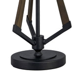 Close-up of the Hilton 1 Light Wood Table Lamp - Black & Grey Without Shade, showing its round black base and three angled legs in dark wood and black metal converging at the center for a striking geometric design.