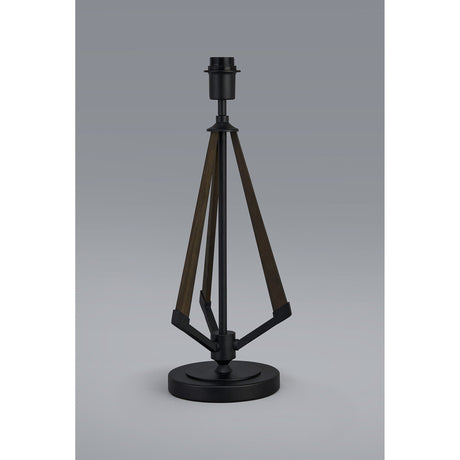 The Hilton 1 Light Wood Table Lamp in black and grey features a round black base with three angled dark wooden arms meeting at a central fixture, creating a sculptural accent. No shade or bulb included.