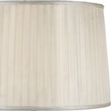A close-up of the Hilton 1 Light Wood Table Lamp’s cream pleated lampshade with silver trim, showcasing its vertical fabric texture and soft, neutral color—paired with a black and grey wood base.