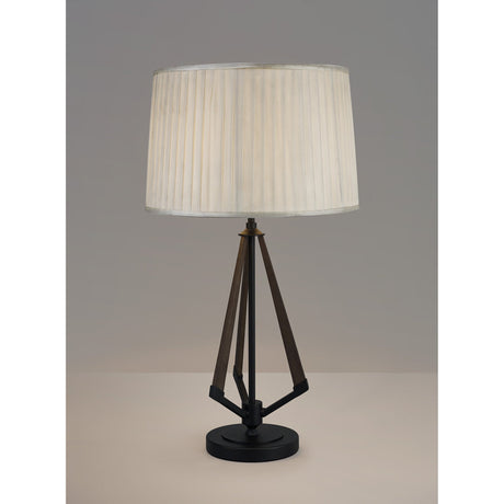 The Hilton 1 Light Wood Table Lamp features a geometric black and grey base paired with a cream pleated shade, shown against a plain gray background.