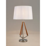The Hilton 1 Light Wood Table Lamp features a nickel and taupe base with angled wooden accents and a modern white pleated shade, displayed on a neutral surface against a plain background.