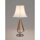 The Hilton 1 Light Wood Table Lamp features a nickel and taupe base with three geometric wooden legs and a cream shade, displayed against a plain gray background.