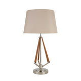 The Hilton 1 Light Wood Table Lamp features a nickel and taupe finish with a nude beige shade and wooden accent rods in a triangular design below the shade.