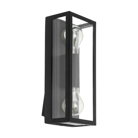 Hirbessa 2 Light Outdoor Wall Light in black steel, a tall rectangular lantern design with clear glass panels and two vertical E27 bulbs, shown on a plain white background.
