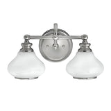The Ainsley 2 Light Wall Light - Polished Chrome is a sleek and modern fixture featuring two frosted glass shades and a polished chrome metal base. Its classic yet contemporary design, equipped with LED lamps, makes it an ideal choice for a variety of room decors.