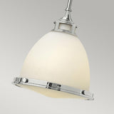 A close-up of the Amelia 1 Light Medium Pendant in chrome showcases its opal glass dome adorned with sleek chrome accents, elegantly suspended against a neutral background.
