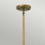 The Amelia 1 Light Medium Pendant - Bronze has a vintage aesthetic with an opal glass dome. It features a round base and a single rod extending downward, set against a plain gray background.