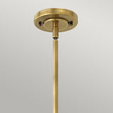 Close-up of the Amelia 1 Light Mini Pendant - Bronze, highlighting a bronze ceiling light fixture with an opal glass dome and a rod extending downwards against a plain gray background. The fixture features a circular mount with a simple, elegant design.