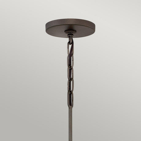 The Astrid 3 Light Chandelier, featuring a round, matte bronze and gold base with a short chain, is elegantly displayed against a plain light-gray background to enhance any space.