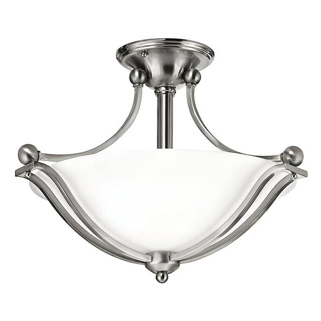 The Bolla 2 Light Semi Flush - Brushed Nickel fixture showcases an elegant design with a brushed nickel finish and frosted white glass shade, complemented by curved metal arms and a central stem connected to a round ceiling mount. This sophisticated piece enhances any home decor beautifully.