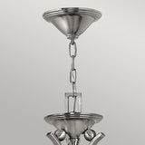 Close-up of the Bolla 5 Light Chandelier's brushed metal chain and two connecting ceiling mounts, showcasing a modern and sleek design. The Brushed Nickel finish enhances this elegant lighting fixture's minimalist and contemporary charm against a soft gray background.