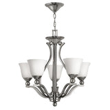 The Bolla 5 Light Chandelier - Brushed Nickel is a modern and elegant lighting fixture featuring five white glass lampshades and a brushed nickel finish on its metal frame. It boasts graceful, curved arms and hangs from a chain, adding sophistication to any space.