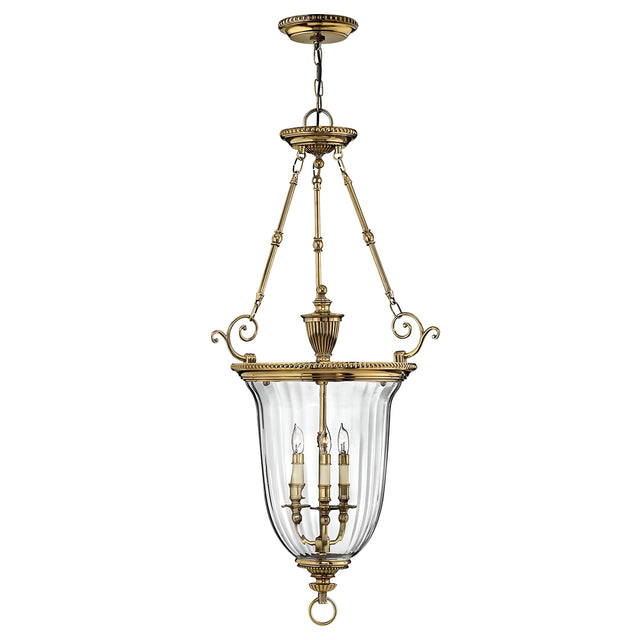 The Cambridge 3 Light Chandelier - Burnished Brass is a vintage-style fixture featuring a transparent glass dome with three candle-like lights. It is supported by ornate brass chains and decorative elements, all crafted in solid brass construction.
