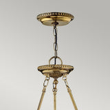 Close-up of a Cambridge 3 Light Chandelier - Burnished Brass, crafted in solid brass. It features a decorative chain and circular plate detailing. The burnished brass fixture boasts an ornate design with intricate beading around the edges, set against a neutral gray background.