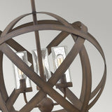 Close-up of the Carson 3 Light Outdoor Chandelier - Vintage Iron, showcasing three glass bulb holders within an intertwined, spherical metal frame. The vintage iron finish adds a touch of rustic charm against the neutral gray background.