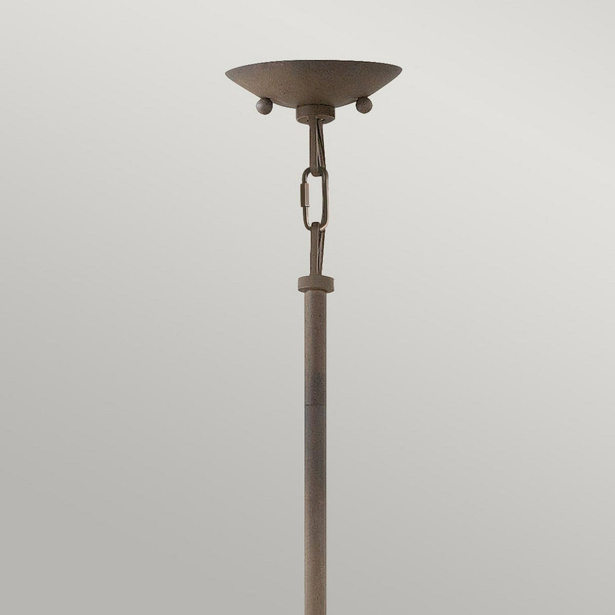 The Carson 5 Light Outdoor Chandelier in Vintage Iron boasts a rustic charm with its tall, slender design featuring a circular, bowl-shaped top and two spherical accents. It is set against a plain light gray background.