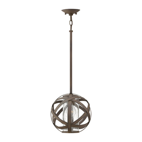 The Carson 1 Light Outdoor Pendant Light in Vintage Iron is a stunning piece, combining modern style with its spherical design of intersecting metal bands. It includes a central glass enclosure for the bulb, supported by a long rod and a ceiling fixture finished in bronze, making it perfect for outdoor use.