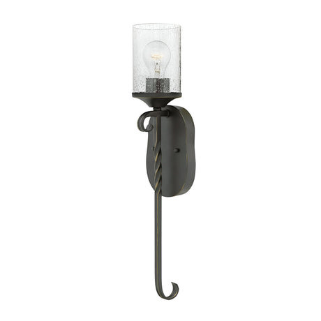 The Casa 1 Light Wall Light - Black is a wall-mounted sconce showcasing a curved design with a clear seedy glass shade and an exposed bulb. This elegant fixture features twisted wrought iron details and a hook-like bottom, adding sophistication to any space.