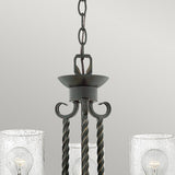 Close-up of the Casa 3 Light Chandelier - Black, showcasing a dark metal frame with twisted rods. It features two seedy glass shades, each housing a visible bulb. This elegant black chandelier is suspended from a chain against a neutral background.
