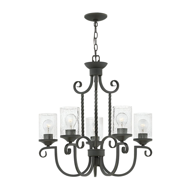 The Casa 5 Light Chandelier in black showcases a sophisticated wrought iron frame with six gracefully curved arms, each holding a bulb nestled within seedy glass shades. This elegant fixture is suspended by a sturdy chain, making it a sophisticated addition to any room.