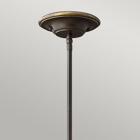 A close-up of the Cello 1 Light Mini Pendant in antique bronze finish features a decorative round finial adorned with a subtle gold trim, elegantly contrasting against a plain light gray background.