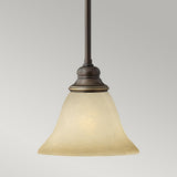 The Cello 1 Light Mini Pendant in antique bronze showcases a frosted glass bell-shaped shade that exudes the charm of vintage faux alabaster glass set against a plain gray background.