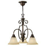 The Cello 3 Light Chandelier - Antique Bronze features decorative scrollwork and vintage faux alabaster glass shades, gracefully hanging from a linked chain. Its classic design is ideal for adding timeless charm to dining or living areas.