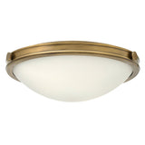 The Collier 3 Light Large Flush - Heritage Brass showcases a Heritage Brass finish along with a white vintage glass dome shade, delivering timeless elegance.