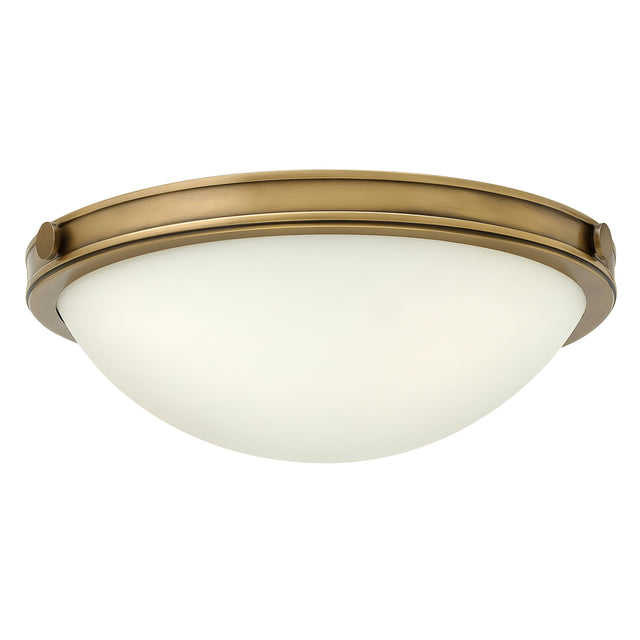 The Collier 2 Light Small Flush - Heritage Brass boasts a round, dome-shaped design with a frosted glass shade, highlighted by a metal rim in Heritage Brass. This chic flush mount light brings an elegant touch to any room.
